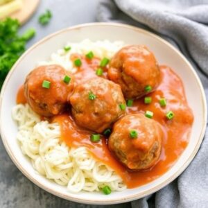 Gluten free meatballs recipe served with marinara sauce and parsley on a white plate 